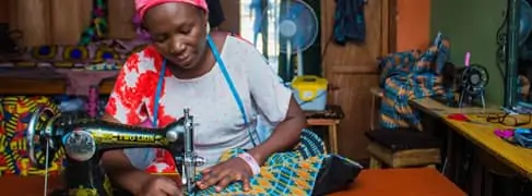 Woman sitting at sewing machine