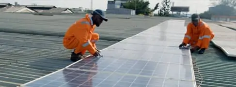 Image of two men installing solar panels