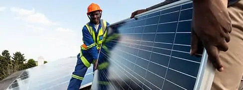 Image of man carrying solar panel